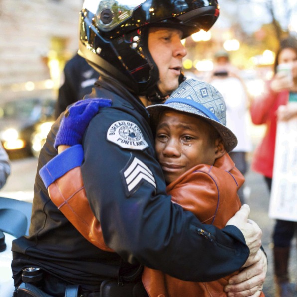 In 2014, Portland police Sgt. Bret Barnum and Devonte Hart, 12, hug at a rally in Portland, Ore., where people had gathered in support of the protests in Ferguson, Mo.